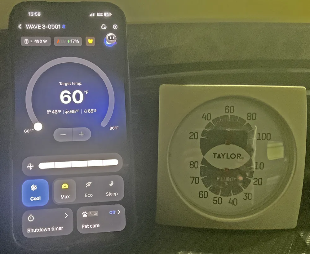 The EcoFlow app on a phone during a cabin cool-down, next to a dial thermometer.