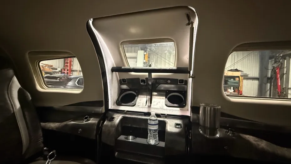 View from inside the cabin: the plenum fills the upper door opening, with two hose ports facing in.
